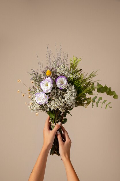 Hands holding beautiful boho flowers assortment