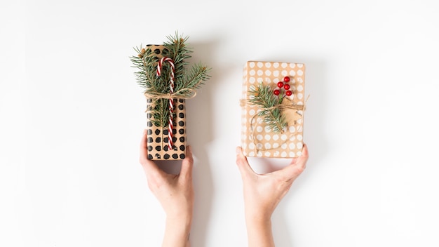 Hands holding beautifully wrapped gift boxes