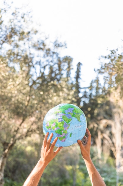 Hands holding blue planet model