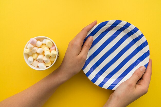 Hands holding blue and white plate