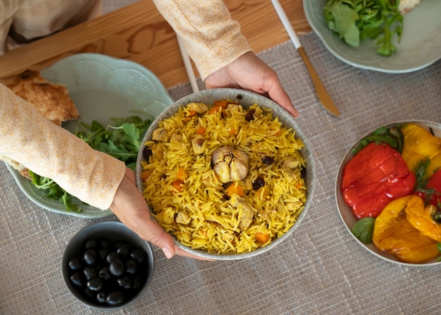 Hands holding bowl of food top view