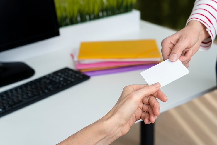 Free Photo hands holding business card high angle