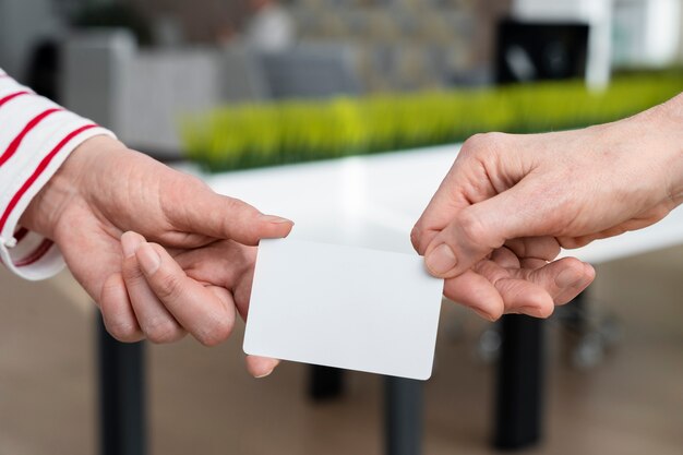 Hands holding business card high angle