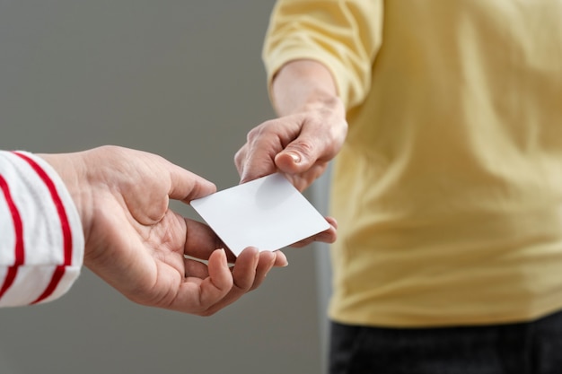 Free photo hands holding business card high angle