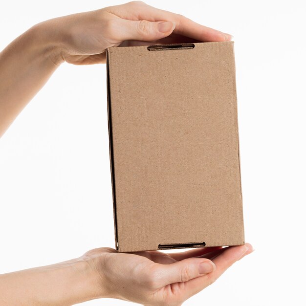 Hands holding cardboard box