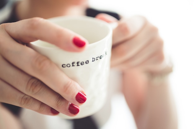 Free photo hands holding a cup of coffee