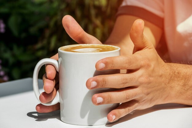 Hands holding cup of coffee