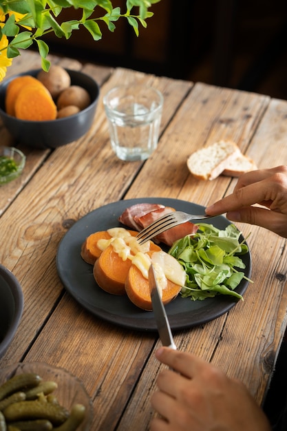 Hands holding cutlery high angle