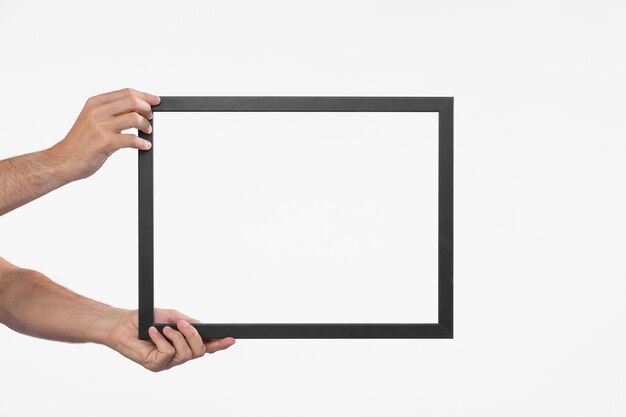 Hands holding dark frame front view
