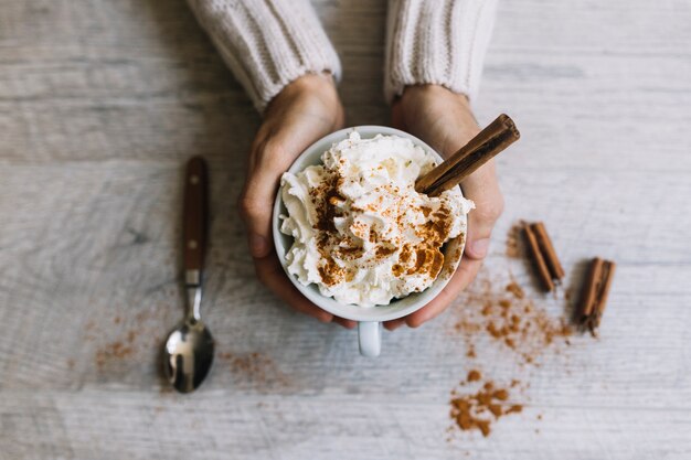 Hands holding delicious hot drink 