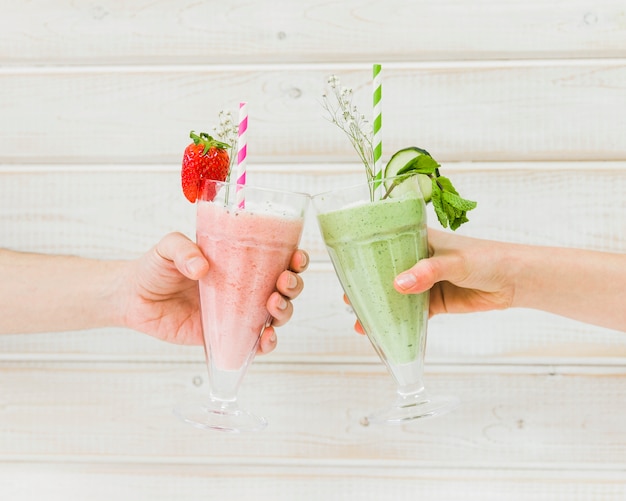 Hands holding delicious summer smoothies