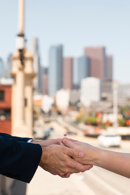 Hands holding each other and  engagement ring