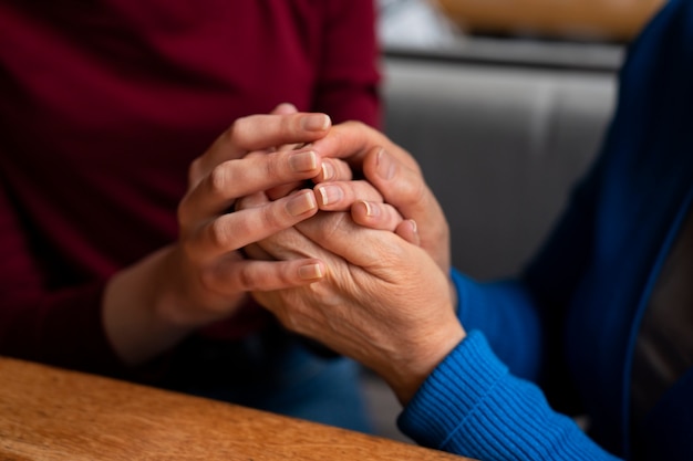 Hands holding each other for support