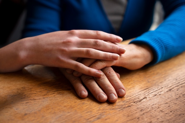 Hands holding each other for support