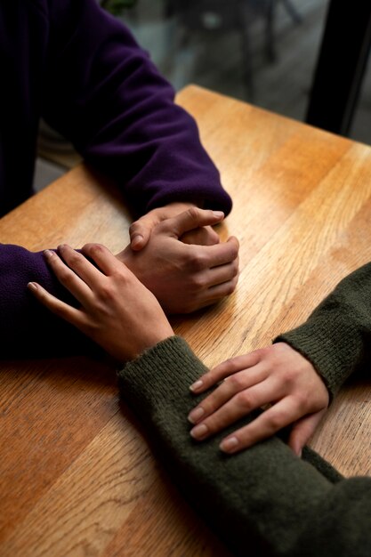 Hands holding each other for support