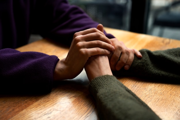 Hands holding each other for support