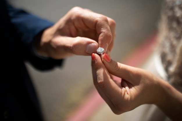 Hands holding engagement ring