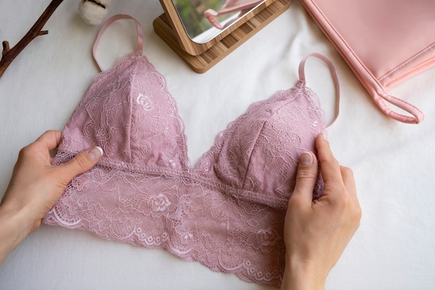 hands holding female bra still life