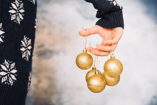 Hands holding five christmas balls