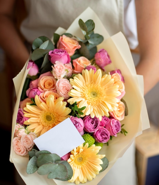 Hands holding flowers bouquet close up