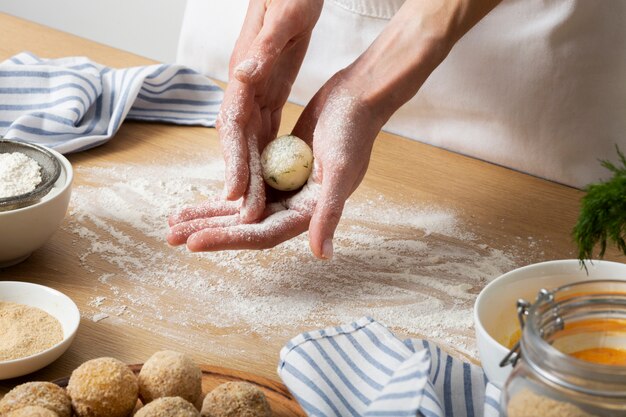 Hands holding food croquette close up