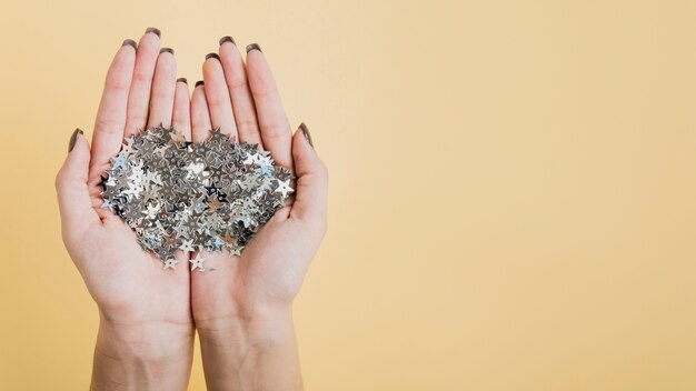 Hands holding glitter with copy space flat lay