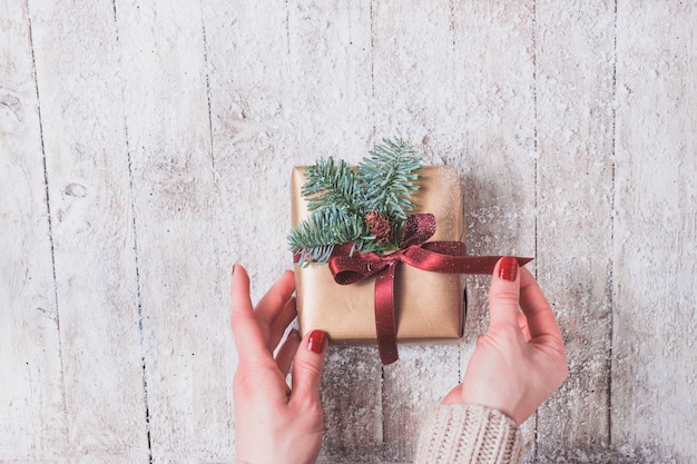 Hands holding a golden present