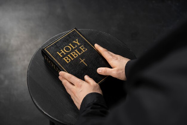 Hands holding holy bible close up