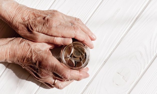 Hands holding a jar of coins