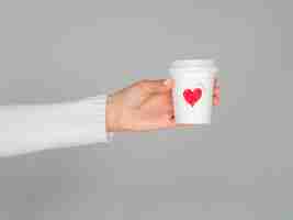 Free photo hands holding love coffee cup