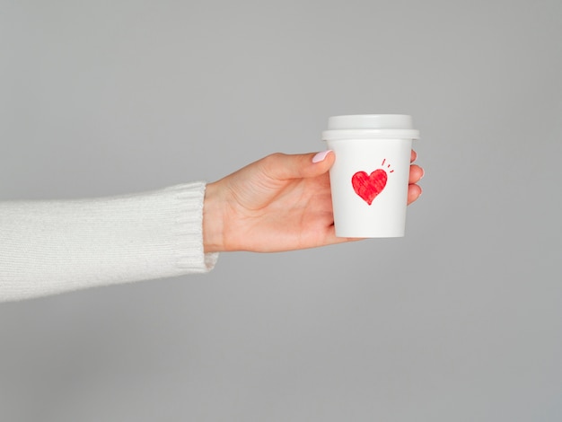Hands holding love coffee cup