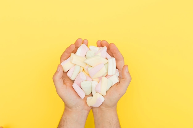 Free photo hands holding marshmallows