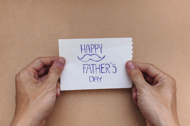 Hands holding a note for father's day
