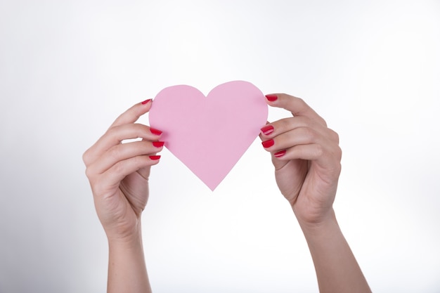 Hands holding a paper heart