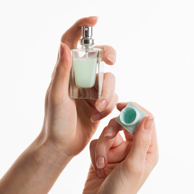 Hands holding perfume bottle