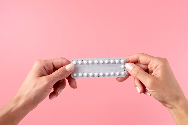 Hands holding pill foil close up