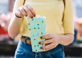 Free photo hands holding popcorn box