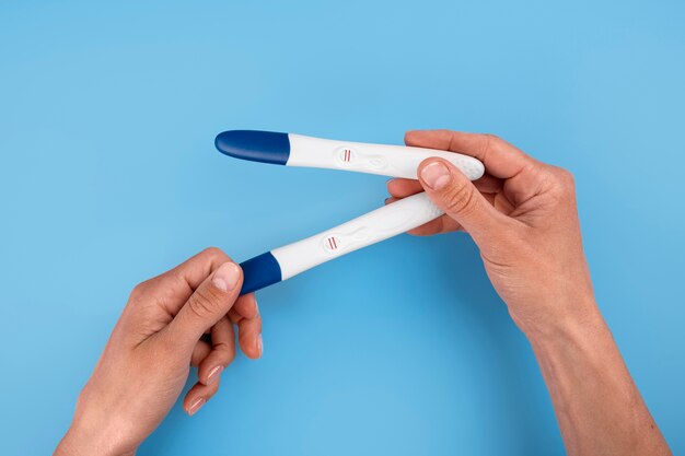 Hands holding positive pregnancy tests