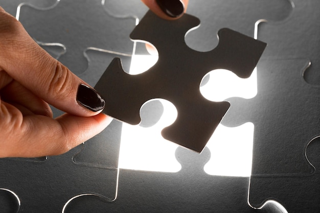 Hands holding puzzle pieces business concept background