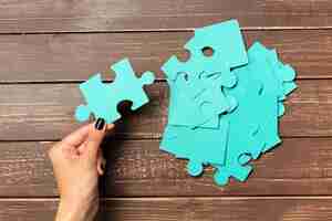 Free photo hands holding puzzle pieces business concept background