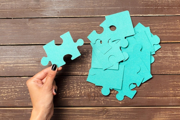 Hands holding puzzle pieces business concept background