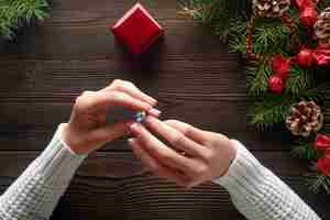 Free photo hands holding a ring with a blue stone