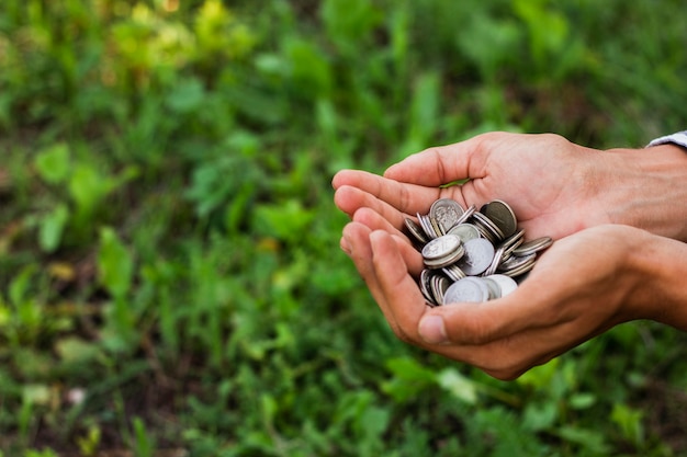 Hands holding saving coins outdoor