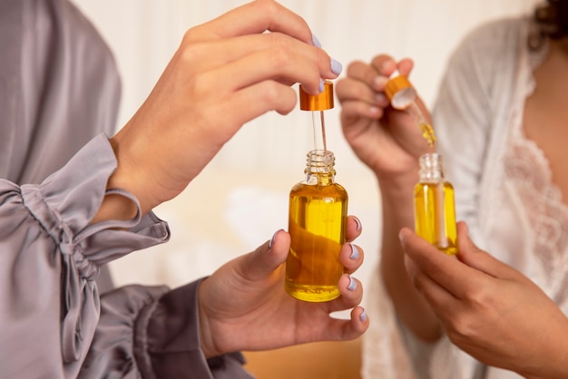 Hands holding serum containers close up