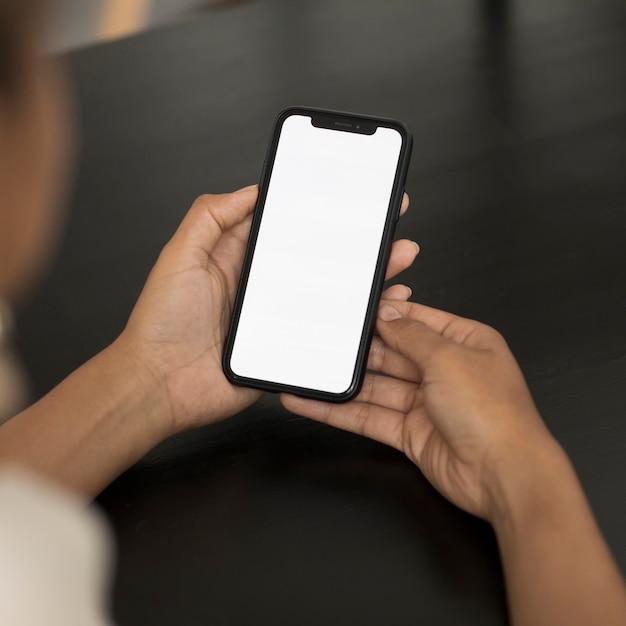 Hands holding smartphone close up