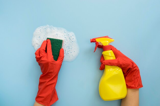 Hands holding sponge and spray bottle