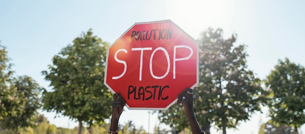 Hands holding stop sign close up