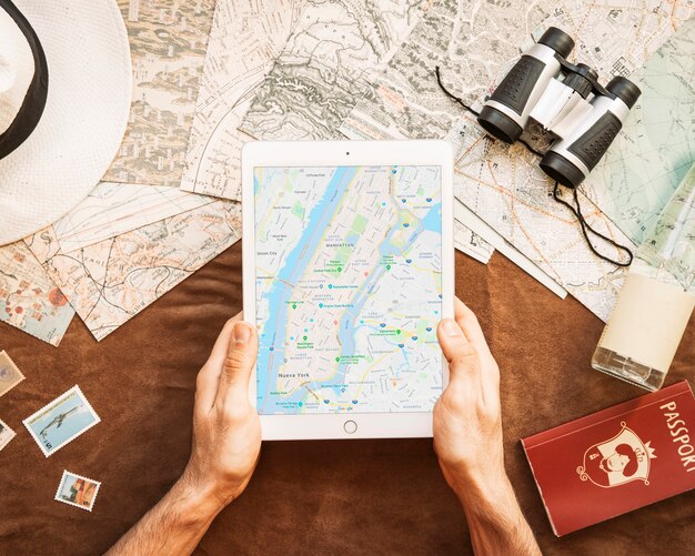 Hands holding tablet with map app
