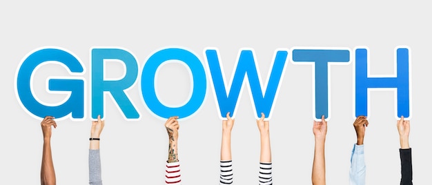 Free photo hands holding up blue letters forming the word growth