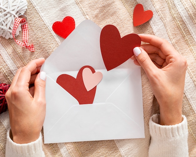 Free photo hands holding valentine envelope